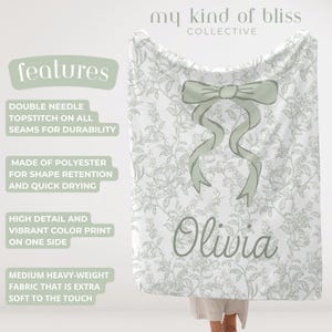 My Personalized Sage Green Bow Toile Name Blanket features a classic olive toile print with delicate flowers and birds on a crisp white background, topped with a big coquette-style bow and your custom name in an elegant script below. Soft feminine and beautifully detailed, it’s perfect for babies, kids, teens and adults. Great for sleepover favors, hospital or coming-home blankets, announcement photos, dorm rooms, teen bedrooms, Christmas, birthdays, sisters, newborn keepsakes and new parents