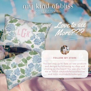 May include: Two rectangular throw pillows featuring a watercolour-style floral pattern in shades of blue, green, and white. The top pillow displays a central white scalloped emblem with the pink monogram letters LGK. Text includes my kind of bliss.