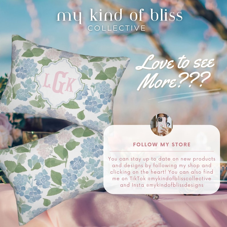 May include: Two rectangular throw pillows featuring a watercolour-style floral pattern in shades of blue, green, and white. The top pillow displays a central white scalloped emblem with the pink monogram letters LGK. Text includes my kind of bliss.