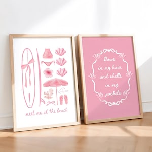 May include: Two framed prints with beach illustrations. One shows a surfboard, bikini, shells, and the text "meet me at the beach." The other has a pink background with the text "Bows in my hair and shells in my pockets."