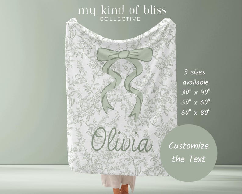 My Personalized Sage Green Bow Toile Name Blanket features a classic olive toile print with delicate flowers and birds on a crisp white background, topped with a big coquette-style bow and your custom name in an elegant script below. Soft feminine and beautifully detailed, it’s perfect for babies, kids, teens and adults. Great for sleepover favors, hospital or coming-home blankets, announcement photos, dorm rooms, teen bedrooms, Christmas, birthdays, sisters, newborn keepsakes and new parents