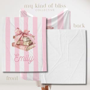 My Custom Name Book Lover Coquette Blanket. Featuring a pink and white striped background with a watercolor book stack wrapped in a bow, this plush blanket is as cozy as it is cute. Add your custom name underneath for a personalized, preppy, coquette touch. Perfect for book lovers, girls bedrooms, baby showers, newborns, or a stylish preppy touch to dorm