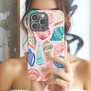 May include: A pink iPhone case with a colorful seashell pattern. The case has a camera cutout and a white background.