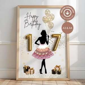 May include: A framed print with a birthday theme. The artwork features a silhouette of a person wearing a crown and a dress made of money, with the numbers "17" as gold balloons. The words "Happy Birthday" are written in cursive, with gold balloons and gift boxes.