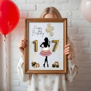 May include: A framed print with a gold-colored frame, featuring a black silhouette of a person in a dress, the number "17", and the words "Happy Birthday". Gold balloons and gift boxes are also included in the design. A red and a pink balloon are in the background.