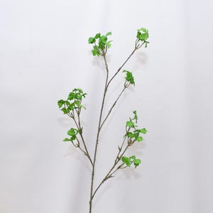 May include: A single artificial stem with multiple branches, featuring small, bright green leaves. The stem is a natural brown color, and the leaves are clustered along the branches. The background is a plain white.