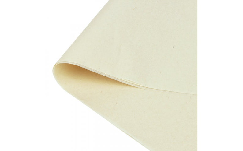 May include: A sheet of off-white tissue paper, folded in half, with a slightly textured surface.