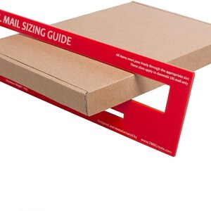 May include: Red plastic Royal Mail Sizing Guide with slots for different package sizes. The guide is designed to help ensure that packages meet the size requirements for domestic UK mail. The text on the guide reads: "All items must pass freely through the appropriate slot. These sizes apply to domestic UK mail only. Designed and manufactured by www.TMBCreate.com."