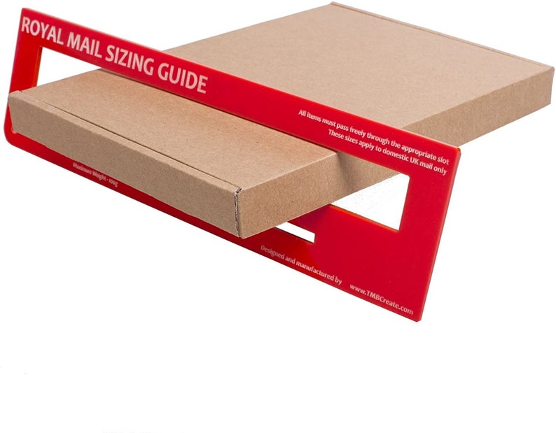 May include: Red plastic Royal Mail Sizing Guide with slots for different package sizes. The guide is designed to help ensure that packages meet the size requirements for domestic UK mail. The text on the guide reads: "All items must pass freely through the appropriate slot. These sizes apply to domestic UK mail only. Designed and manufactured by www.TMBCreate.com."