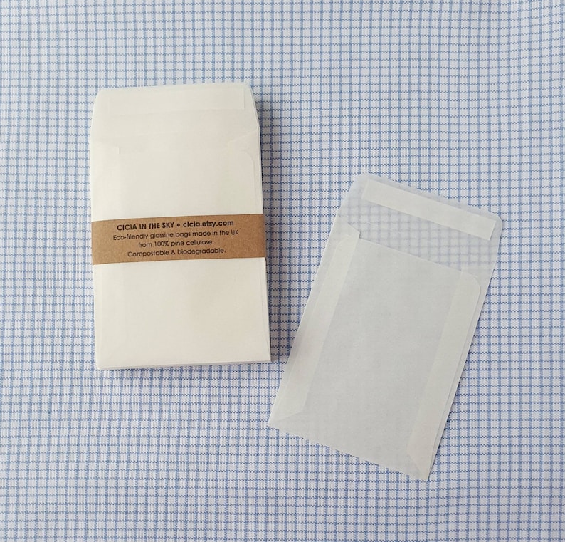 May include: A stack of white, eco-friendly glassine bags made from 100% pine cellulose. The bags are compostable and biodegradable. The text on the label reads: "CICIA IN THE SKY * ciclo.etsy.com Eco-friendly glassine bags made in the UK from 100% pine cellulose. Compostable & biodegradable."
