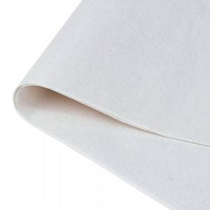 May include: A close-up of a white felt sheet, showing the texture of the fabric.