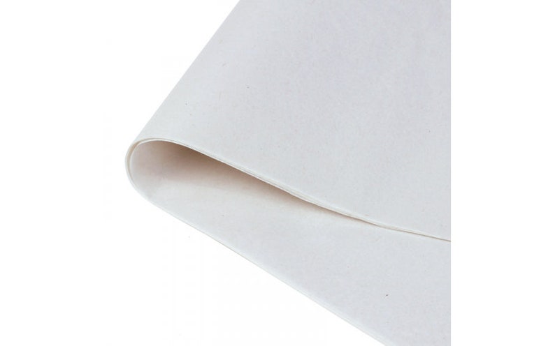 May include: A close-up of a white felt sheet, showing the texture of the fabric.