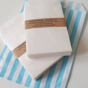 May include: A stack of white, eco-friendly glassine bags made in the UK from 100% pine cellulose. The bags are compostable and biodegradable. The text "CICIA IN THE SKY cicia.etsy.com" is printed on a brown label.