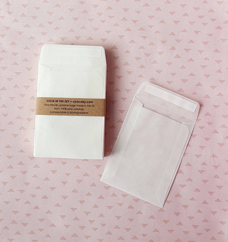 May include: A stack of white, eco-friendly glassine bags made from 100% pine cellulose. The bags are compostable and biodegradable. The text on the bag reads: "CICIA IN THE SKY - cicia.etsy.com Eco-friendly glassine bags made in the UK from 100% pine cellulose. Compostable & biodegradable."