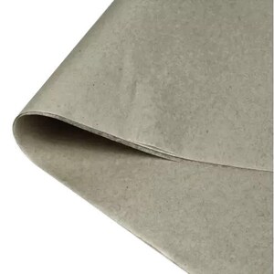 May include: A close-up of a sheet of light brown craft paper. The paper has a slightly textured surface.