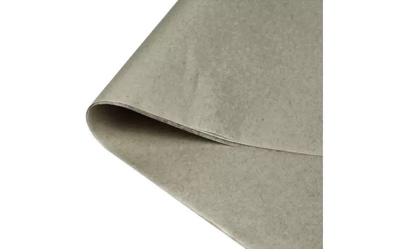 May include: A close-up of a sheet of light brown craft paper. The paper has a slightly textured surface.