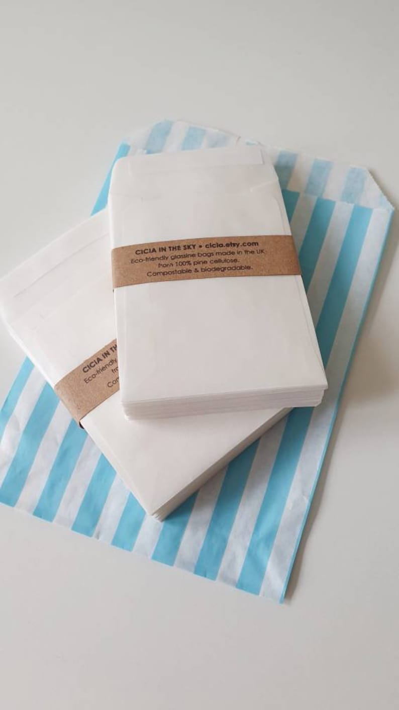May include: A stack of white, eco-friendly glassine bags made in the UK from 100% pine cellulose. The bags are compostable and biodegradable. The text "CICIA IN THE SKY cicia.etsy.com" is printed on a brown label.