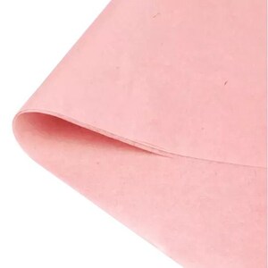 May include: A sheet of light pink tissue paper. The paper has a slightly textured surface.