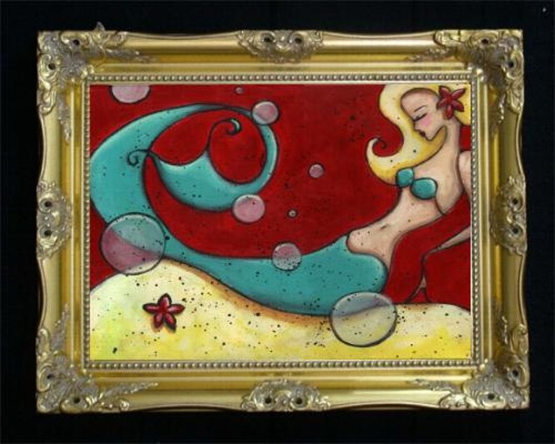 May include: A framed painting of a mermaid with blonde hair and a red flower, wearing a teal bikini top. The background is red with bubbles and a teal wave. The mermaid is on a yellow sandy area with a red starfish.