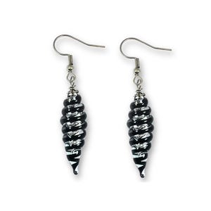 May include: A pair of dangle earrings with a black and white spiral design. The earrings have a silver-colored hook and a decorative spiral-shaped bead. The beads are black with white stripes, creating a contrasting pattern.