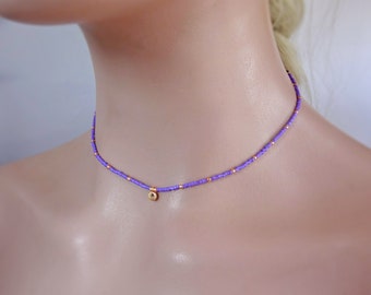 Collar de gargantilla unisex minimalista con cuentas de color púrpura claro con detalles en oro y colgante, joyería juvenil de playa.