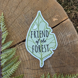 an illustrated green leaf sticker with text that says "friend of the forest"