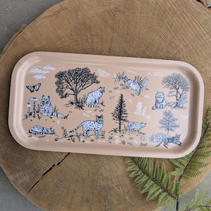 May include: A rectangular metal tray with a beige background and a black and white design of cats and trees. The tray features a whimsical pattern of cats in various poses, surrounded by trees and leaves.