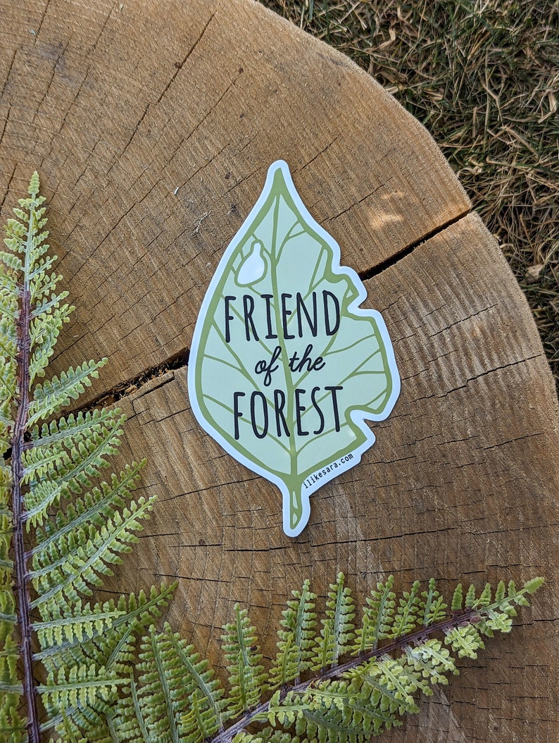 an illustrated green leaf sticker with text that says "friend of the forest"