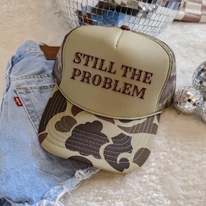 Still the Problem Trucker Hat – Funny Beige Cowgirl Rodeo Cap