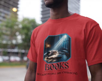 May include: Red t-shirt with a graphic featuring a cat sleeping on a book near a window with sunlight streaming through. The word "BOOKS" is below the image, with the text "BECAUSE PEOPLE ARE EXHAUSTING" underneath.