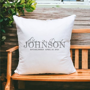 May include: White throw pillow with the text "Olivia & Daniel JOHNSON ESTABLISHED APRIL 20, 2024" printed in gray.