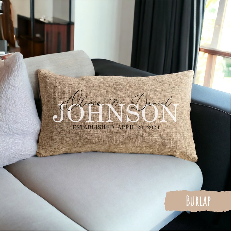 May include: A burlap pillow with the text "Olivia & Daniel JOHNSON ESTABLISHED APRIL 20, 2024" in black and white lettering.