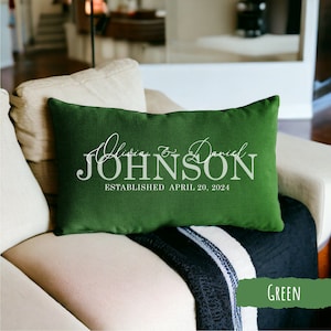 May include: Green throw pillow with white text that reads "Olivia & Daniel JOHNSON ESTABLISHED APRIL 20, 2024".