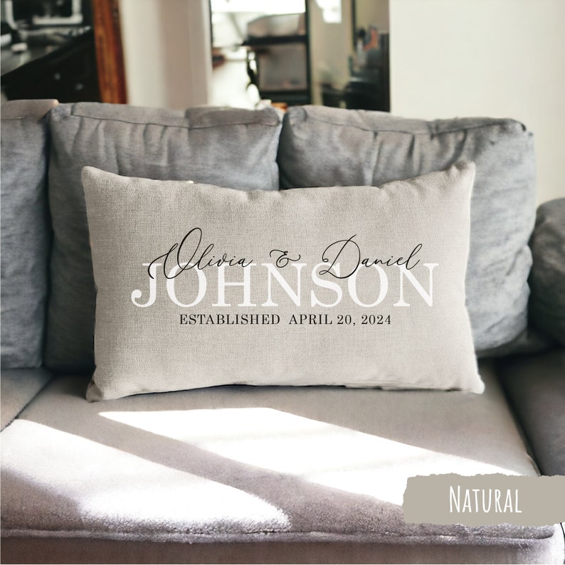 May include: A natural linen throw pillow with the text "Olivia & Daniel JOHNSON ESTABLISHED APRIL 20, 2024" printed in black.