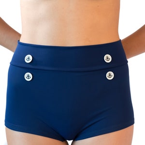 Classic navy blue high waisted retro bikini bathing suit with metal star buttons Navy boy shorts paired with a vintage look halter top. image 4