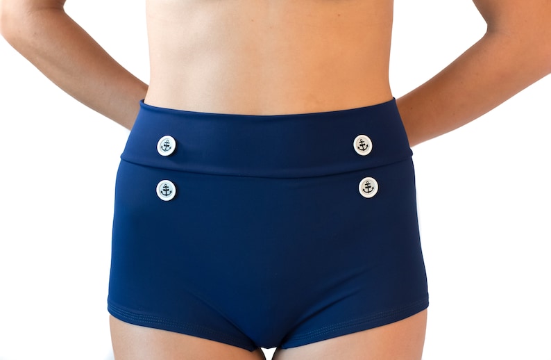 Classic navy blue high waisted retro bikini bathing suit with metal star buttons Navy boy shorts paired with a vintage look halter top. image 4