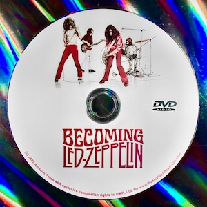 May include: A DVD disc featuring the band Led Zeppelin. The disc has an image of the band members performing on stage. The title "BECOMING LED-ZEPPELIN" is printed in red. The DVD logo is visible.