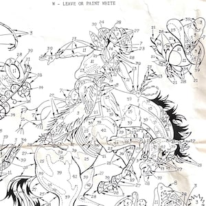 May include: A black and white line art coloring page of a cowboy riding a bucking horse. The page is numbered 3627 and includes a color chart with instructions for coloring the image.