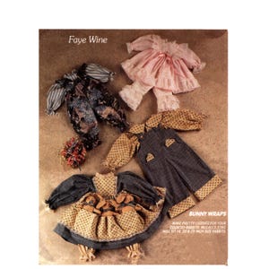 May include: An assortment of doll clothes in various styles and colors. The image includes a pink outfit with lace trim, a blue and patterned outfit, and a yellow and blue dress with bunny accents. The text "BUNNY WRAPS" is visible.