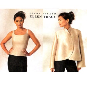 May include: Two women modeling clothing from Linda Allard Ellen Tracy. The woman on the left is wearing a sleeveless ivory top and black pants. The woman on the right is wearing a long-sleeved ivory jacket and black pants.
