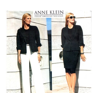 May include: Anne Klein Vogue American Designer advertisement featuring a black blazer worn with a black top and white trousers, and a black blazer worn with a black top and a black skirt. The blazer has three-quarter sleeves and a single button.