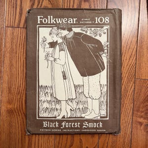 May include: A brown Folkwear Ethnic Patterns - 108 sewing pattern envelope. The cover features a black and white illustration of a couple in traditional clothing. The text "Black Forest Smock" is at the bottom.