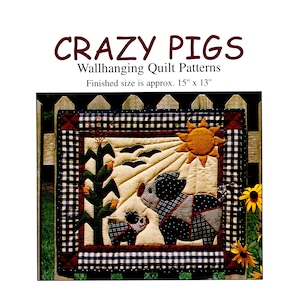 May include: A quilted wall hanging featuring two pigs, a sun, and corn stalks. The quilt has a black and white checkered border and the text "CRAZY PIGS" at the top. Finished size is approximately 15" x 13".