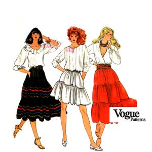 May include: Three women's fashion illustrations wearing different styles of white blouses and tiered skirts. The skirts are black, white, and red. The illustration is labeled "Vogue Patterns".