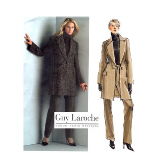 May include: A Guy Laroche Vogue Paris Original sewing pattern featuring a long-sleeved blazer and trousers. The image displays a photograph of the finished garment in a dark textured fabric alongside a tan-coloured fashion illustration sketch.