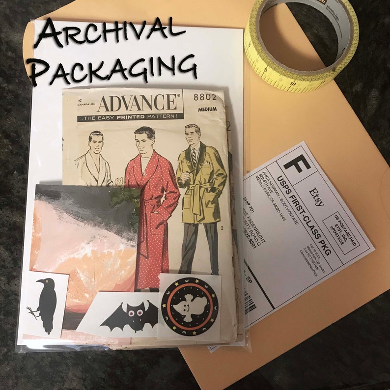 May include: An Advance 8802 sewing pattern envelope featuring illustrations of men in robes, accompanied by a black crow sticker, a bat sticker, a ghost sticker, a tan mailing envelope, and a roll of yellow measuring tape with inch markings.