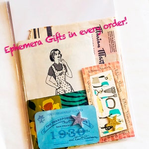 May include: A collection of vintage paper ephemera in a clear sleeve, including a sewing pattern illustration of a person in a polka dot apron, a Kitchen Shower card with kitchenware graphics, and a 1930 San Francisco transportation membership card.
