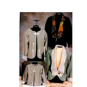 May include: Four jackets are displayed on mannequins. The jackets are in various colors, including black, olive green, and gray. One gray jacket has white floral embroidery and a unique clasp. Another jacket has a patterned scarf. The jackets are displayed against a neutral background.