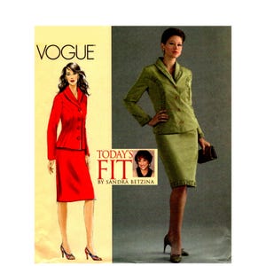 May include: A Vogue sewing pattern envelope featuring a red two-piece suit illustration on the left and a photograph of a green two-piece suit on the right. The text reads VOGUE, TODAY'S FIT BY SANDRA BETZINA, and includes a small portrait.