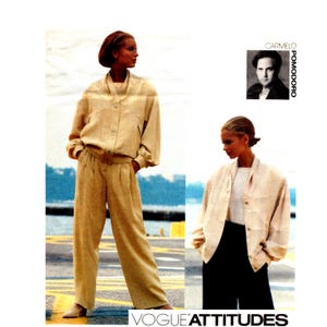 May include: An advertisement featuring a beige two-piece suit with a bomber jacket and wide-leg pants. The jacket has a button-up front and the pants have a pleated front. The image also includes a smaller photo of a man and the text "CARMELO POMODORO" and "VOGUE ATTITUDES".